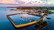 © kipply - Coastal town and harbor with moored boats under a pastel sky, captured from above at a peaceful moment