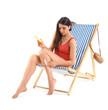 © Pixel-Shot - Beautiful young woman applying sunscreen cream in deck chair on white background