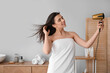 © Pixel-Shot - Pretty young woman with hair dryer in bathroom