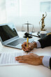 © Kieng - A lawyer reviews and signs legal documents at a modern office desk, symbolizing contract agreements, legal consultation, compliance, business law, and professional legal services.