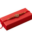 © Monoara - Traditional Indian Rakhi on Red Gift Box