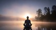 © Kita - Person meditating in yoga pose on lake water at sunrise with morning mist