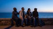 © Agus Through Lens - Diverse senior friends sitting on stone wall by the ocean at twilight, retirement and aging gracefully concept