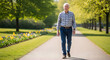 © iron89 - Senior Man Walking in Park: An elderly man in casual attire strolls along a sun-dappled pathway in a park, surrounded by blooming flowers and mature trees.