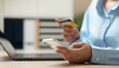 © Father_Studio - Young woman using credit card for online shopping and digital payment through mobile banking application and e-commerce platform.