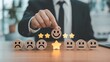 © Baloch - Businessman Placing Smiley Face on Rating Scale with Five Gold Stars on Wooden Table in Office
