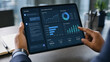 © Yuliia Yevdokymova - Businessman using tablet to analyze sales dashboard data and AI chatbot insights at office desk