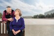 © BillionPhotos.com - Senior couple smiling and looking at each other on a park bench outdoors with copy space