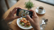 © bephoto - 日本人の手がカフェの料理をスマートフォンで撮影する写真