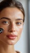© Asier - Woman applying cosmetic product with a brush, enhancing natural skin and emphasizing beauty