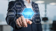 © TANZIM22 - Businessman touching glowing hexagonal marketing strategy diagram