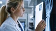 © amimf - Female Doctor Analyzing Patient Hand X-ray in Hospital Clinic