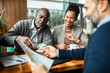 © Marko Geber - Mature couple meeting with financial advisor at cafe