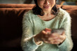 © Davor - Woman using smartphone on cozy sofa at home