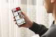 © New Africa - Man reading online newspaper on mobile phone indoors, closeup