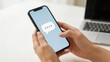 © 奇 锐 - Hands holding smartphone with messaging icon