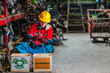© SpaceOak - Male technician inspecting used auto parts for refurbishing and recycling in scrapyard