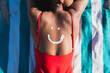 © Martí Rosselló - Person relaxing on beach with sunscreen smiley face