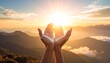 © pp - Uplifting hands embrace sunlight above distant mountain ranges during a serene golden sunset/sunrise