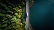 © Zarana  - Aerial view of a white semi-truck driving on a bridge between a forest and water