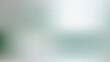 © Sumon - Abstract blurred background with soft light and grainy texture in shades of green and grey