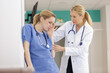 © auremar - senior doctor wasking after the wellbeing of junior colleague