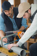 © auremar - men cut plastic pipe for heating and water supply