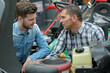 © auremar - men checking lawn mower
