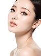 © Ilham - Woman with natural makeup looks forward against a clean white background for beauty concepts.