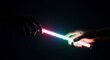 © fitri - Two hands holding glowing light sticks in a dark environment.