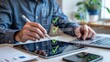 © Busness studio - Professional reviewing digital checklist on tablet with stylus while collaborating in modern office workspace