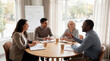© Aurora Aesthetics - group mentorship coaching diverse team meeting guidance leadership support learning small circle listens to experienced mentor during bright collaborative session around table with notebooks for