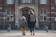 © SilentSmog - Mother and child walking hand in hand to school entrance with entrance backpacks education students building historic architecture learning parenting childhood daylight lifestyle together