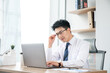 © DoThanhKhanh - Focused businessman working on laptop in modern office