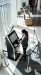 © Handon - Modern Self Service Kiosk Interaction In A Bright Contemporary Lobby Setting