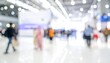 © Gang - A blurred image of a bustling indoor space with people walking
