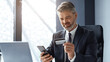 © Prostock-studio - Focused Middle Aged Caucasian Man Holding Credit Card While Using Smartphone At Desk In Modern Office. Engaged In Online Payment Or Transaction Activity. Business Concept