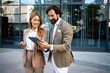 © Zoran Jesic - Business people using digital tablet and smartphone outdoors