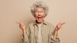 © Polpimol - hooray elder woman indicate empty space wear spectacles shirt isolated on color background, joyful, cheerful, adult, achievement, retirement, happy, happiness, success