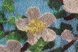© Zakyy - Textured surface of a traditional floral tapestry rug highlighting pastel colors and dense fibers.
