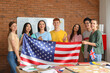 © Pixel-Shot - Young students with USA flag at language school