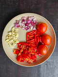 Chopped Fresh Ingredients with Red Chili, Shallots, Garlic, and Tomatoes on a Plate for Indonesian Sambal