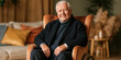 © S-DESIGN - An elegant elderly man is seated in a plush armchair, exuding warmth and contentment. His dignified presence and gentle smile create an inviting atmosphere.