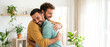 © AIRina - Two men hugging joyfully indoors in a bright, modern living space - Concept of International Men's Day