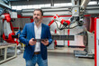 © BusinessClass by W61 - Manager holding tablet in modern automated manufacturing plant