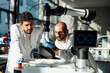 © BusinessClass by W61 - Researchers examining robotic arm in modern laboratory
