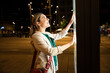 © BusinessClass by W61 - Tourist using interactive digital map on city street at night