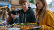 © Maksym - Group of teenagers at a school lunch table one standing visibly hesitating holding tray outsider looking at a closed social circle teen peer pressure belonging anxiety adolescence social dynamics mi