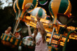 © VISTA by Westend61 - Catching a large soap bubble at an illuminated amusement park