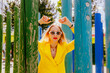 © VISTA by Westend61 - Happy freelancer in yellow suit relaxing at modern park